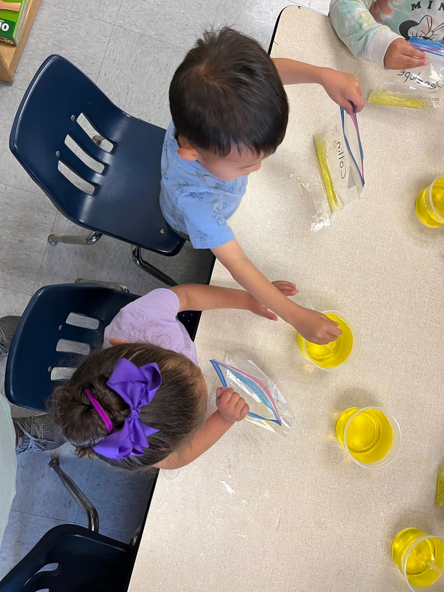 Children doing a hands-on color mixing science activity at school